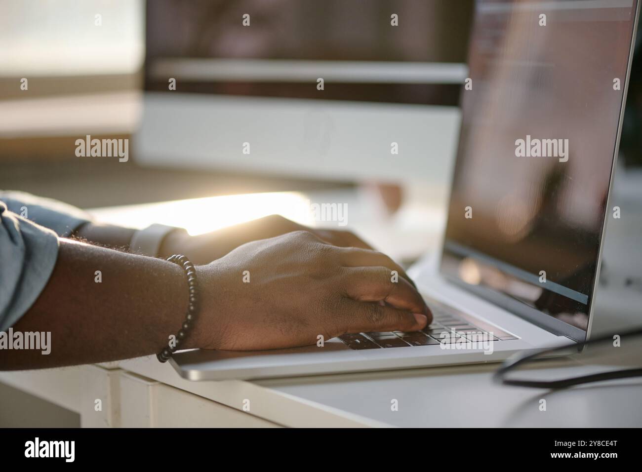 Unrecognizable male hands typing on black keyboard Stock Photo