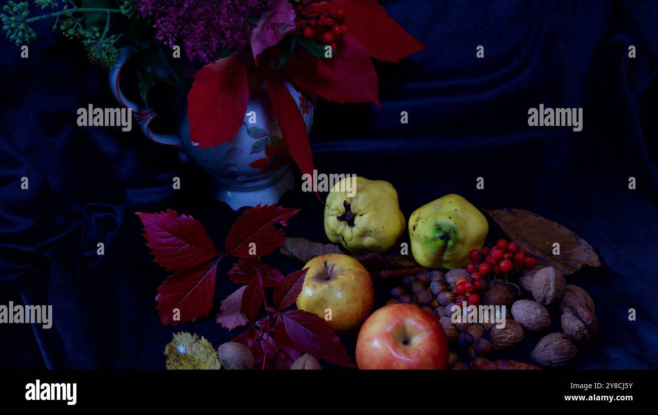 A vase with flowers- Apples, walnuts. quinces, hazelnuts. Stock Photo
