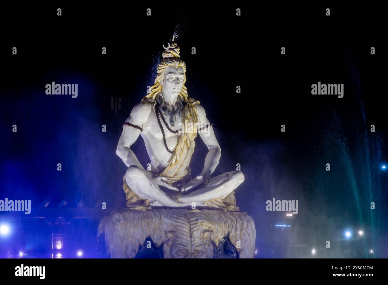 dramatic idol of hindu holy god lord shiva sitting in mediation at outdoor at night Stock Photo