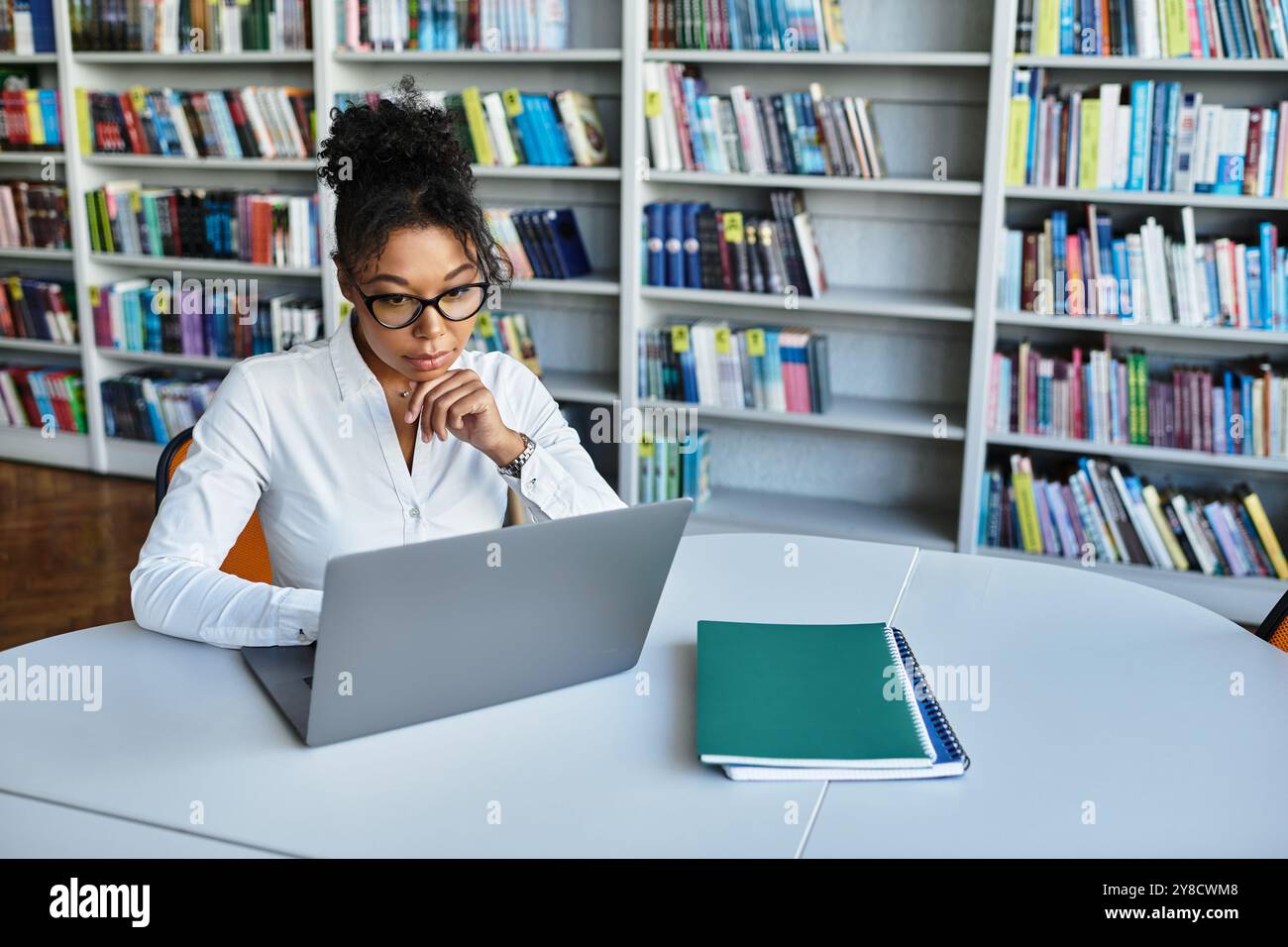 A dedicated African American teacher thoughtfully prepares lessons at ...