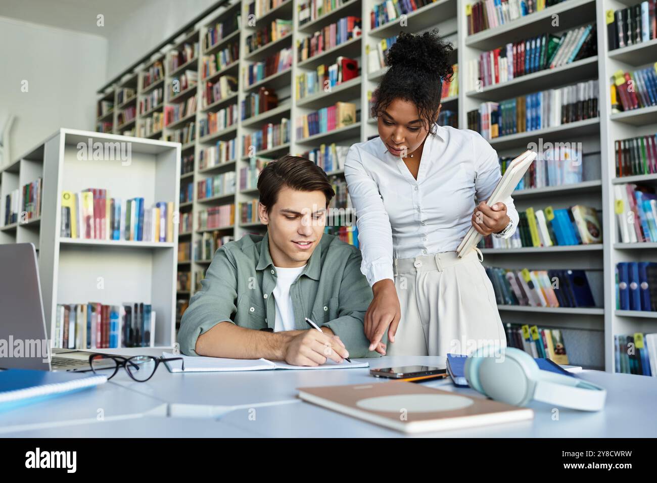 A dedicated teacher assists her student with a focused lesson in a ...