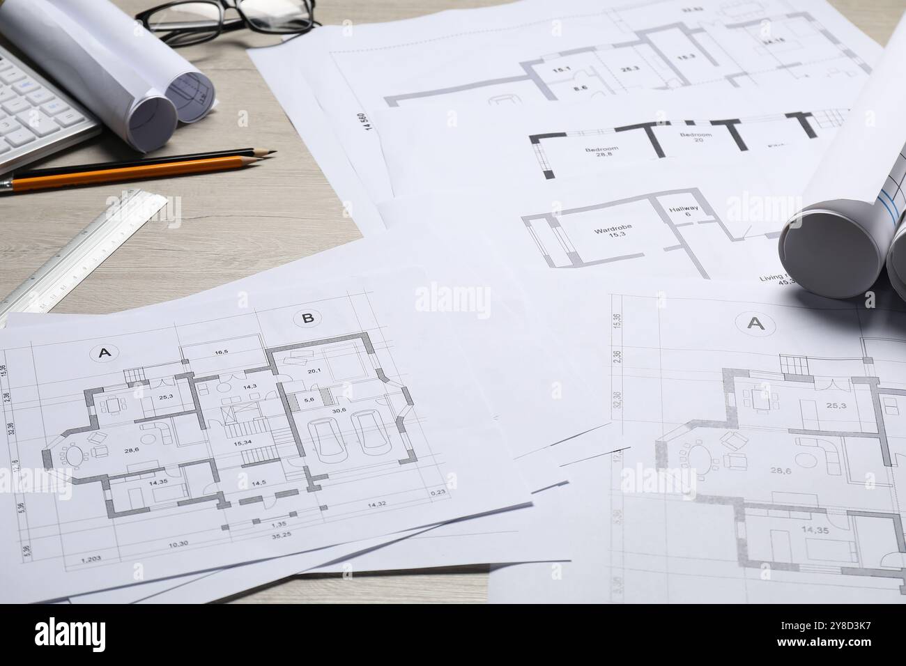 Different architectural drawings and tools on wooden table, closeup ...