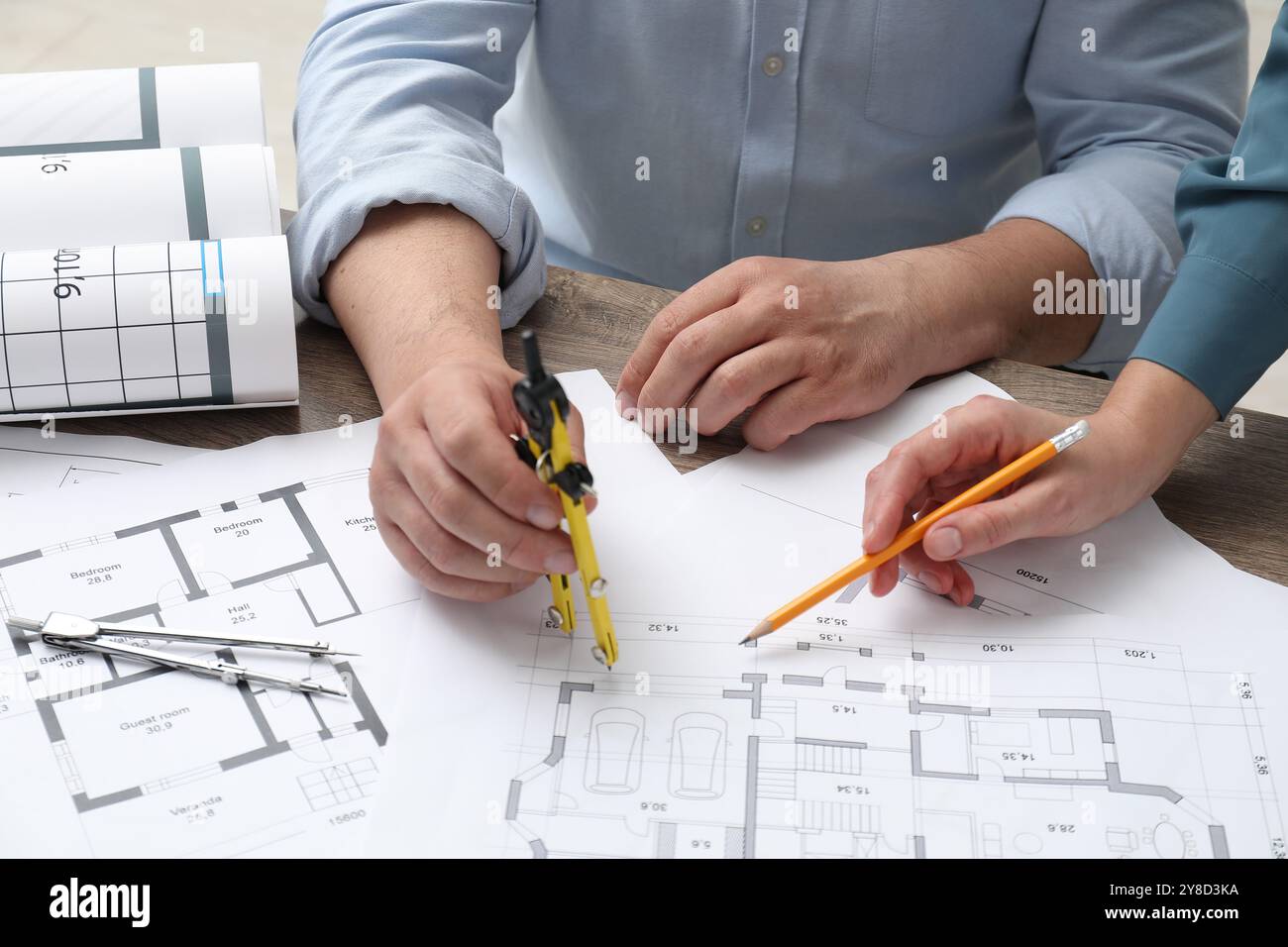 Architects working with project, closeup. Different technical drawings on wooden table Stock Photo