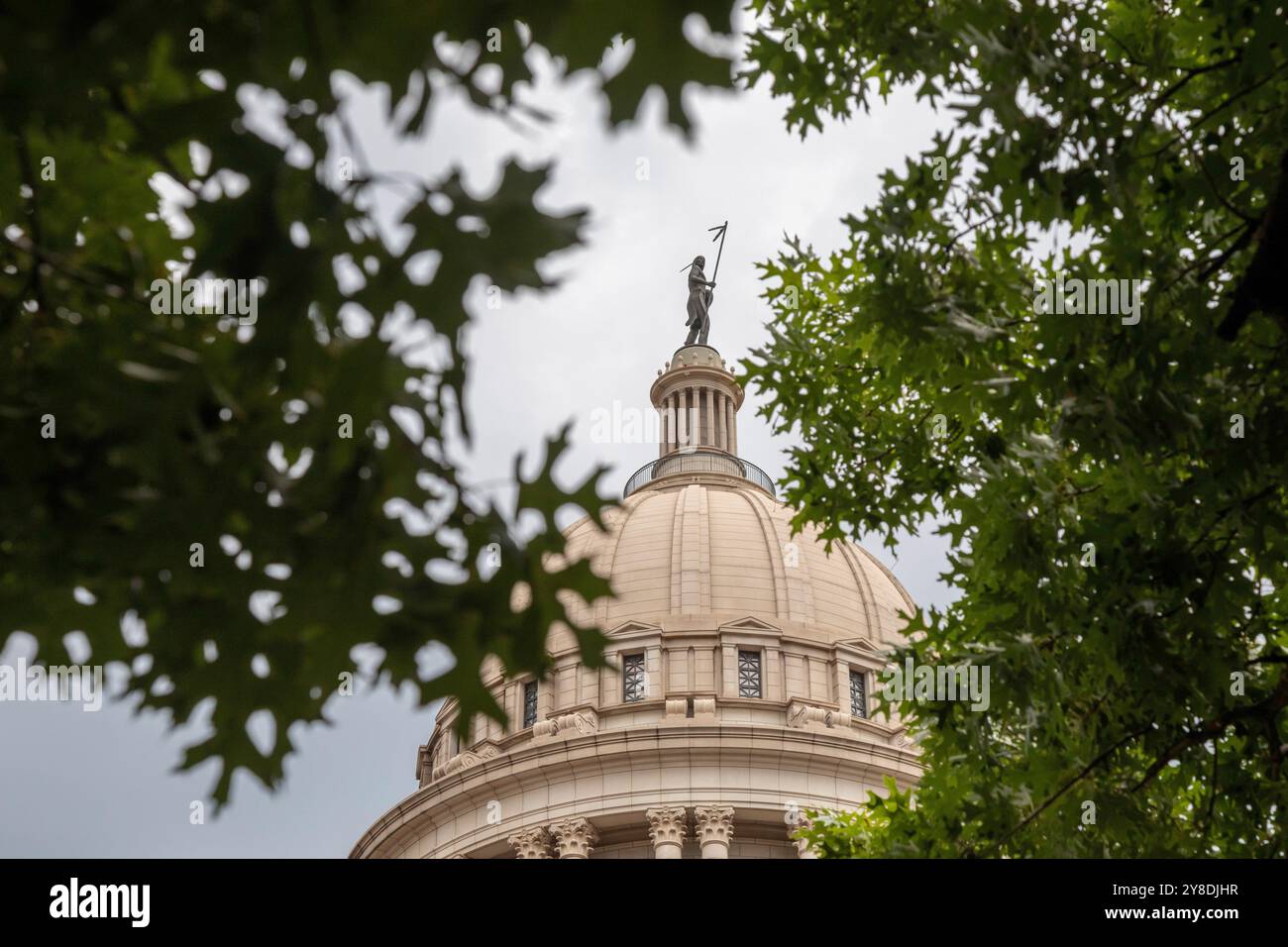 Oklahoma City, Oklahoma - The Oklahoma state capitol building. 'The Guardian,' a bronze statue by former state senator and member of the Seminole Nati Stock Photo