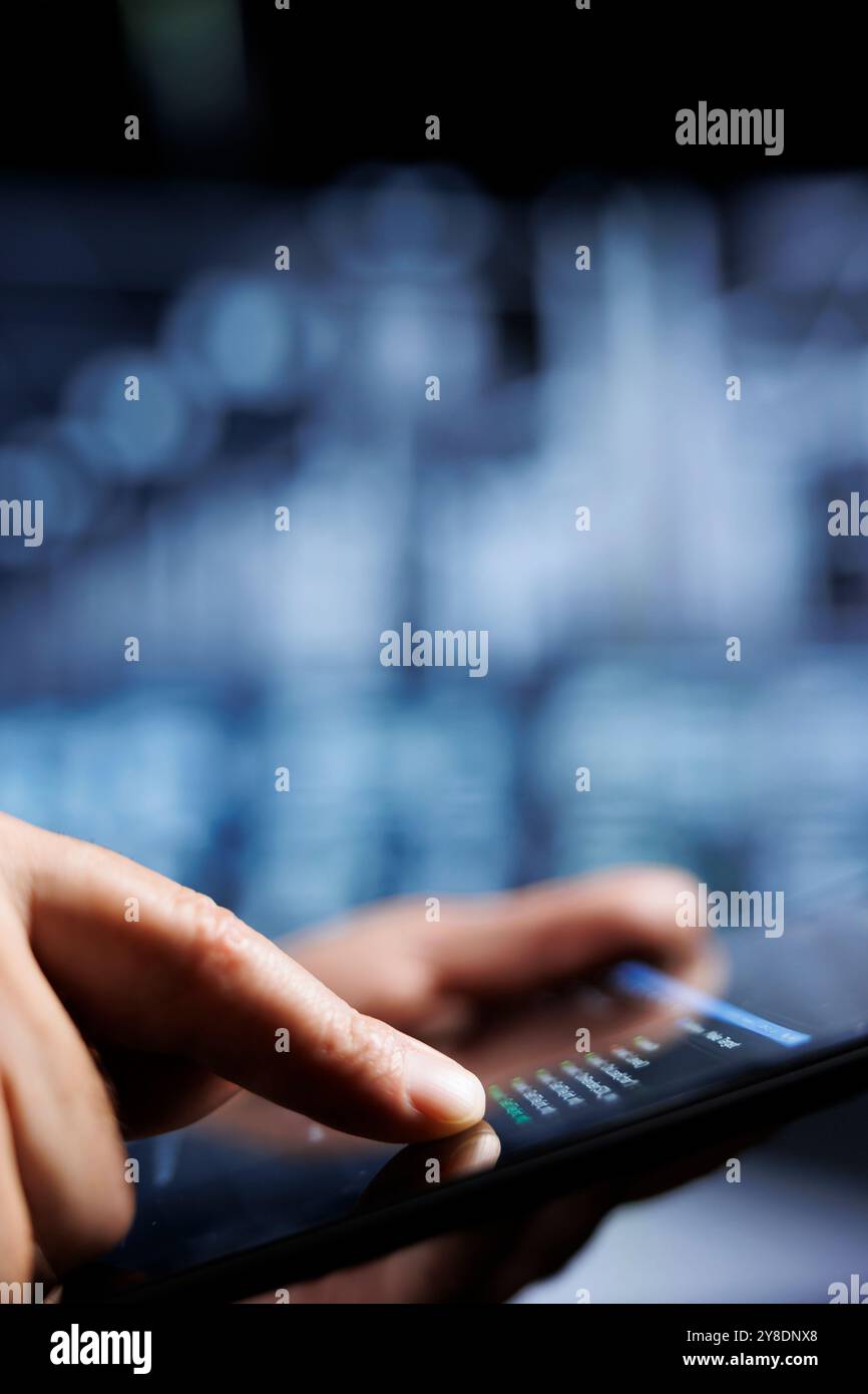 Close up of certified system administrator updating server rigs, writing intricate binary code scripts on tablet. Computer scientist using programming to fortify cybersecurity in high tech place Stock Photo