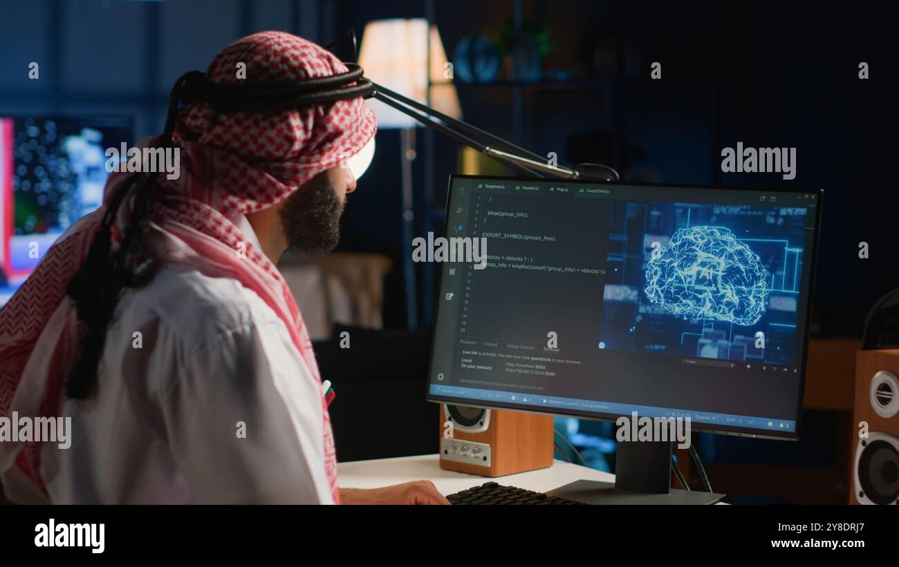 Experienced Arab developer programming scripts on computer screen, employing AI machine learning, manipulating lines of code for artificial intelligence applications computing Stock Photo