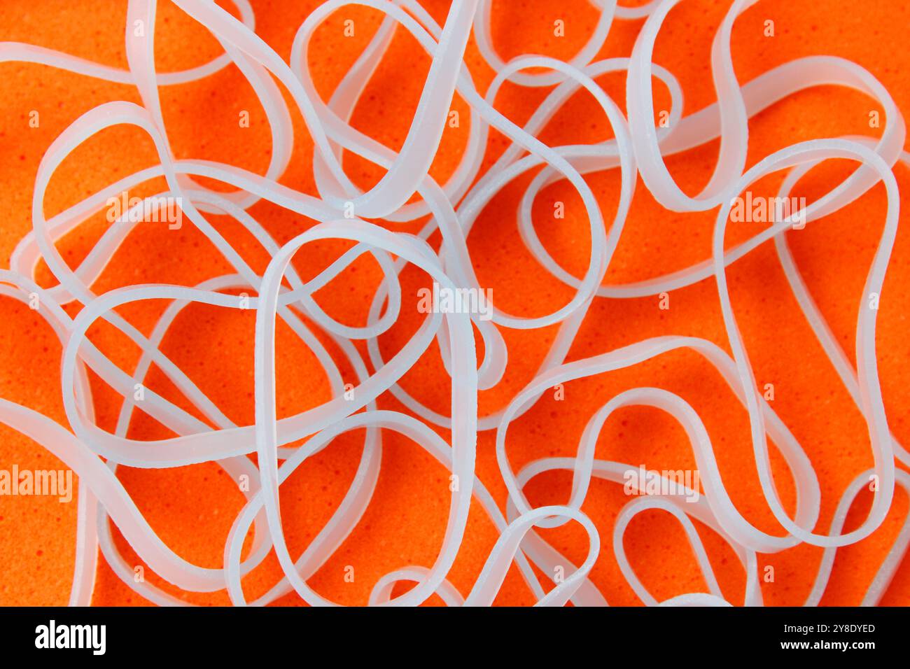 Light blue elastics on an orange background Stock Photo