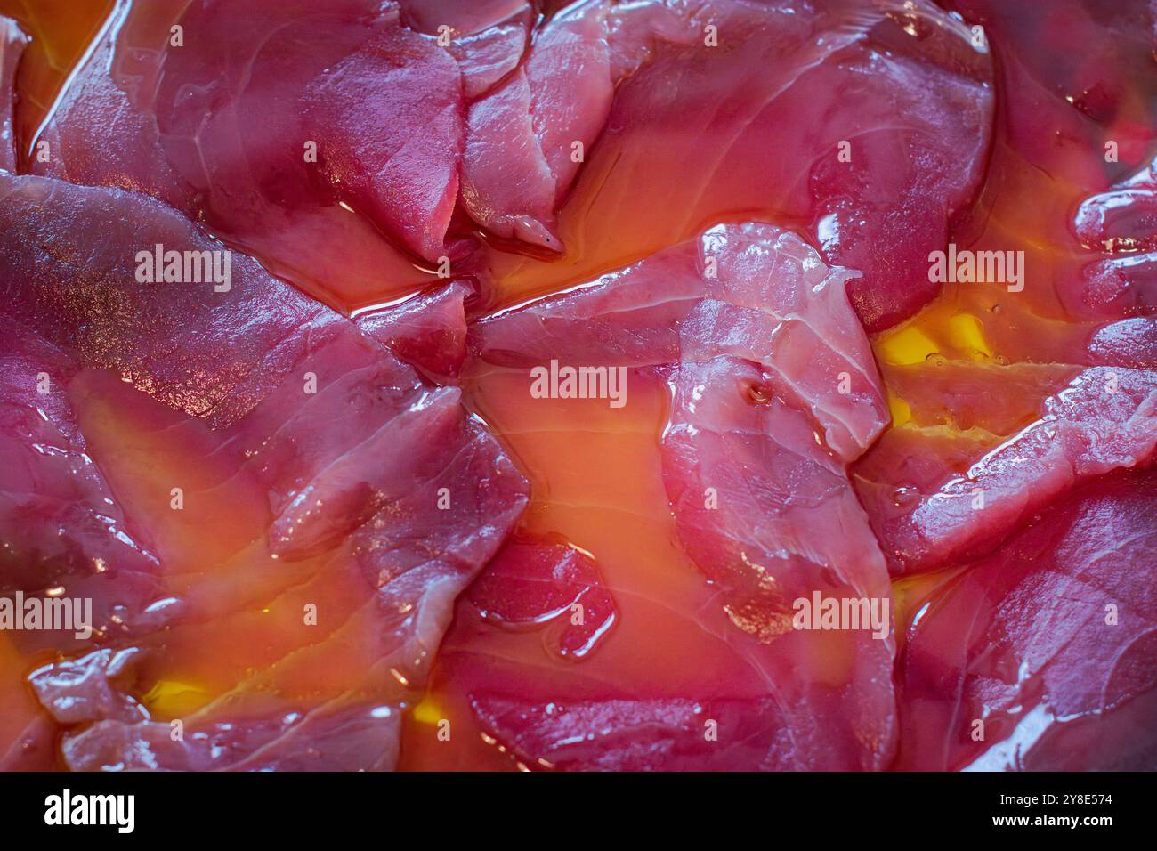 Raw Tuna Slices and olive oil. Stock Photo