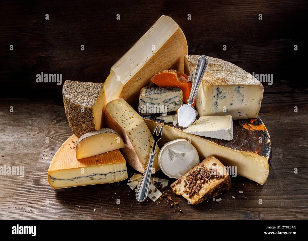 A beautiful Artisan Cheese Selection artfully arranged on a Rustic Wood ...