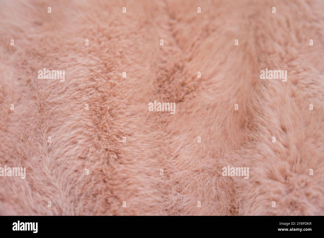 Soft texture of a faux fur coat in warm peach fuzz tones Stock Photo ...