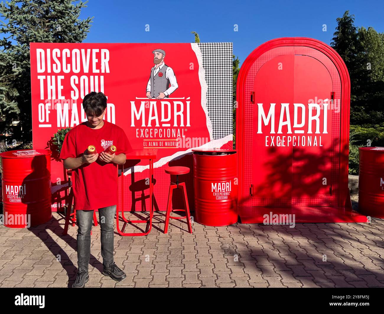 Promo boy offers free samples of Madri beer cans at a promotional point as a marketing campaign in Sofia Bulgaria, Eastern Europe, Balkans, EU. - Smartphone Captured Stock Image