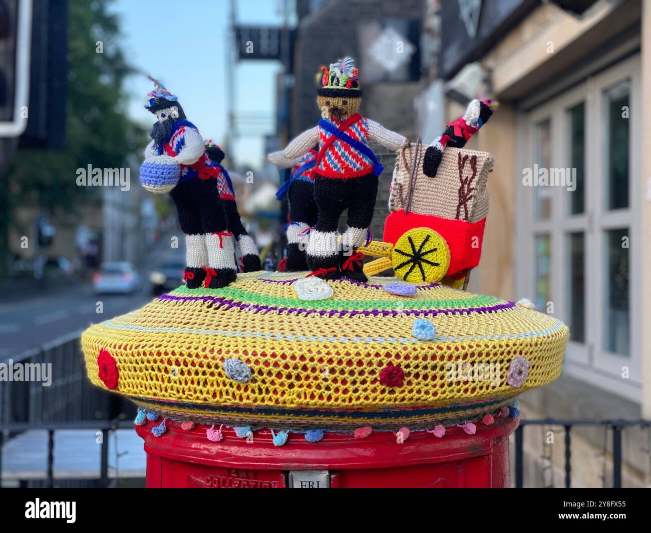 Saddleworth rushcart knitted dancers on top of post box, Saddleworth, Oldham, Greater Manchester, U.K. - Smartphone Captured Stock Image