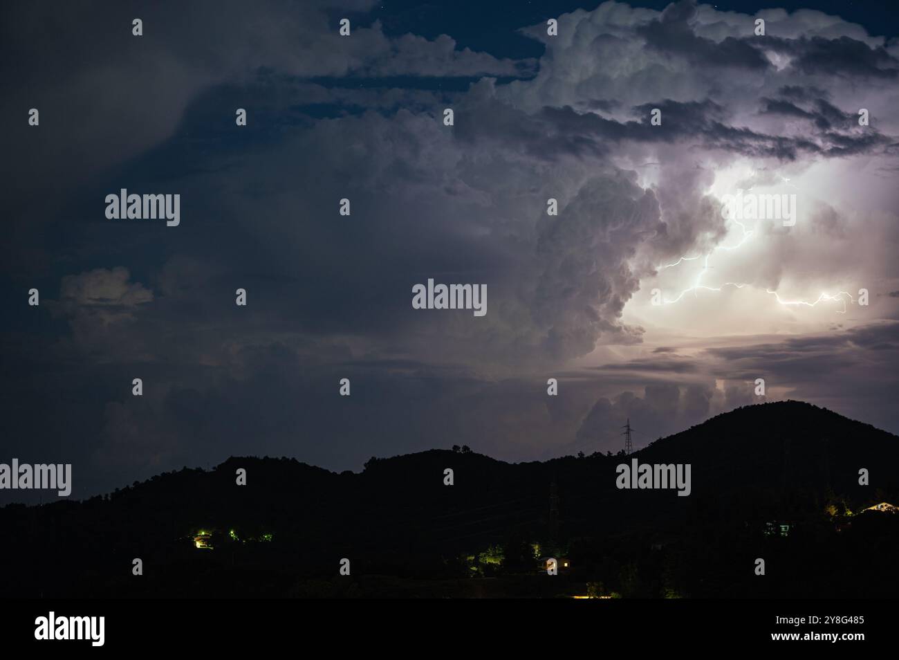 Majestic storm cloud is illuminated by lightning flashes at night Stock ...