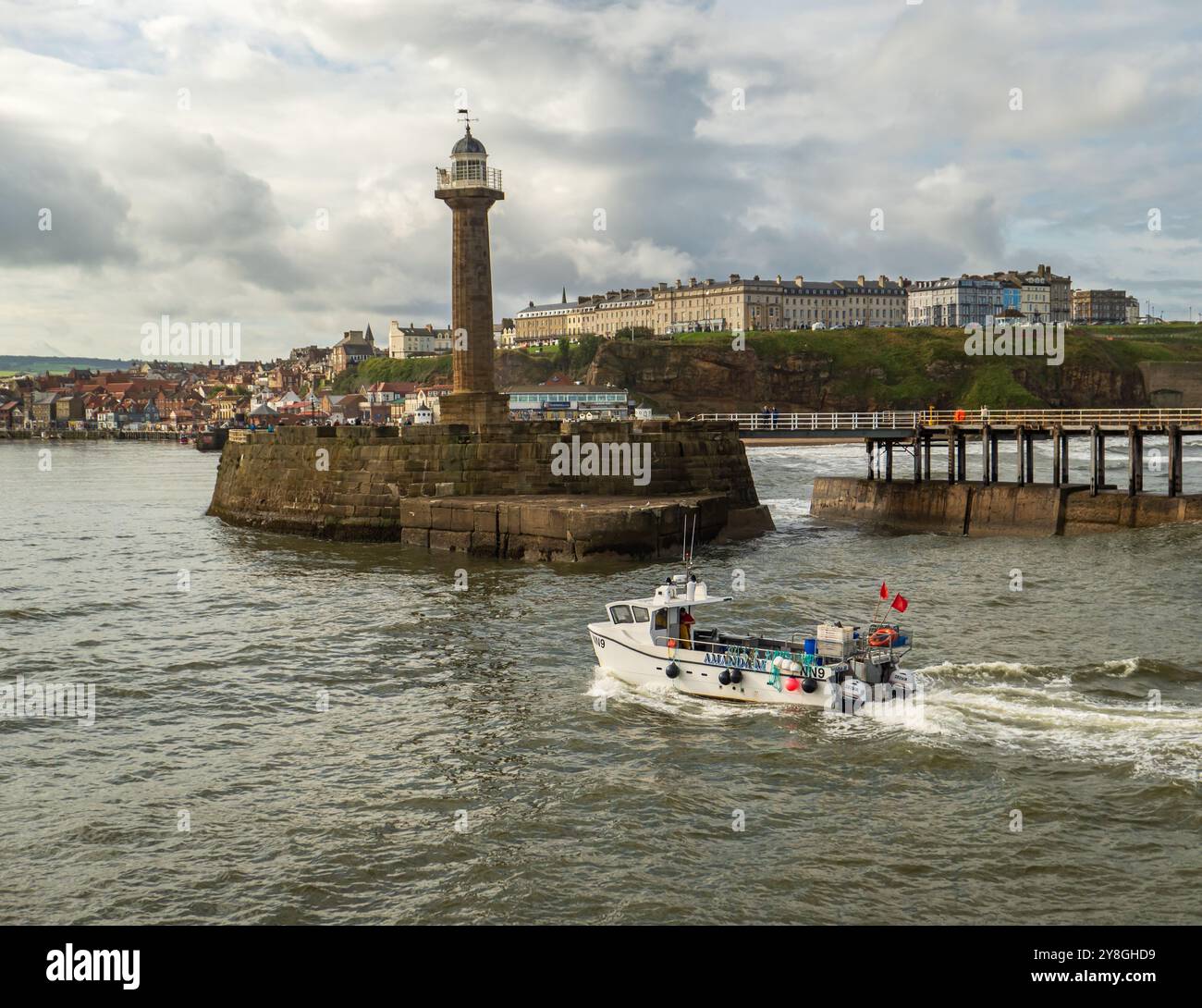 Fishing boat returning to harbour Stock Photo - Alamy