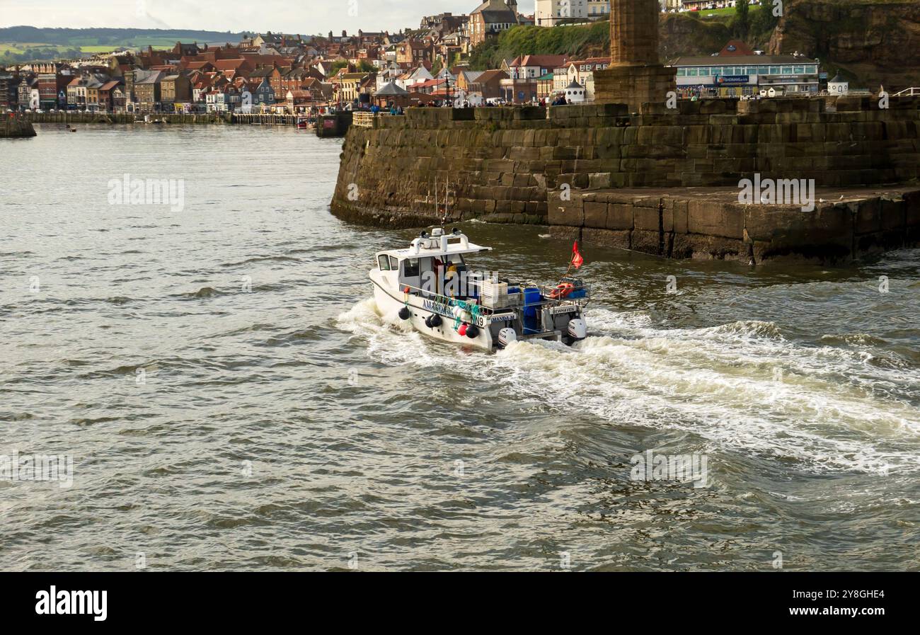 Fishing boat returning to harbour Stock Photo - Alamy