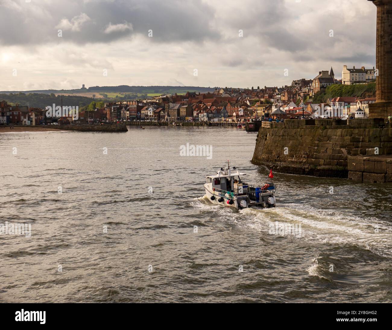 Fishing boat returning to harbour Stock Photo - Alamy
