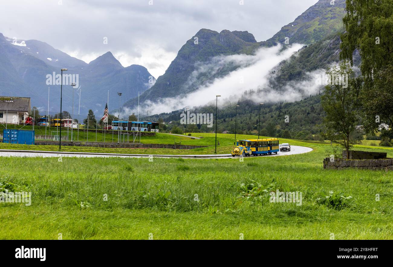 Olden Train Olden, Norway 15 Aug, 2024 - A tourists's train chugs along a winding ...