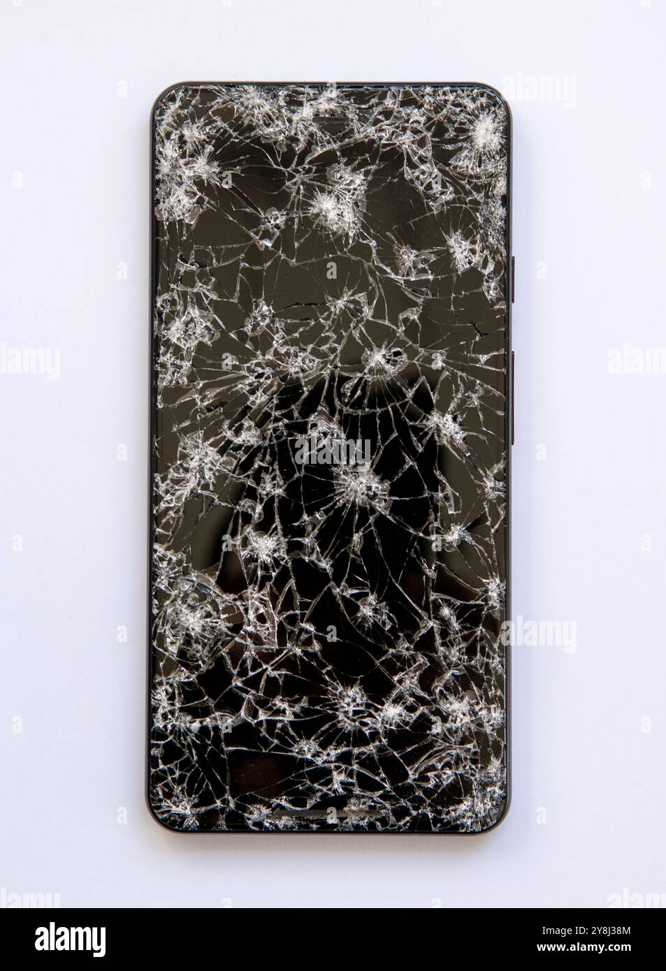 Smartphone with broken screen showing crack lines on the glass in close ...