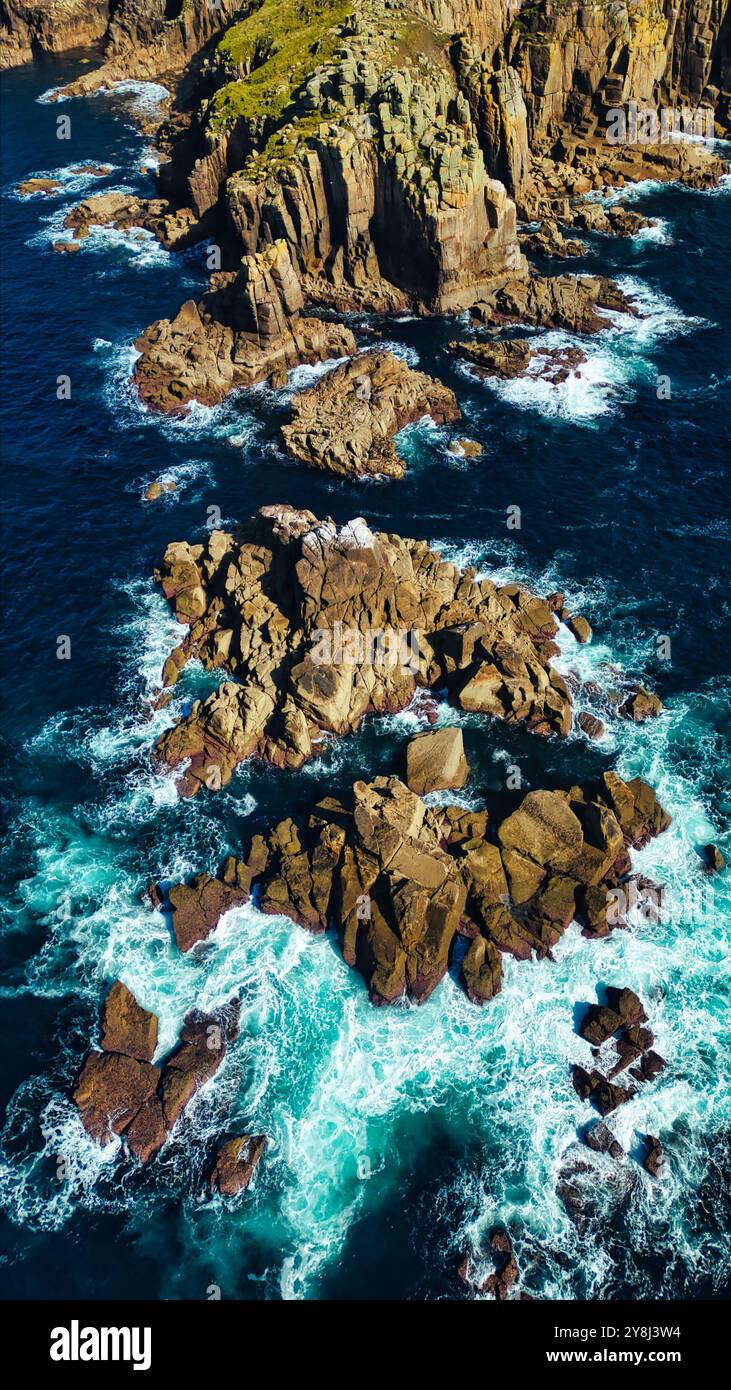 Aerial view of rocky coastline with waves crashing against the rocks ...