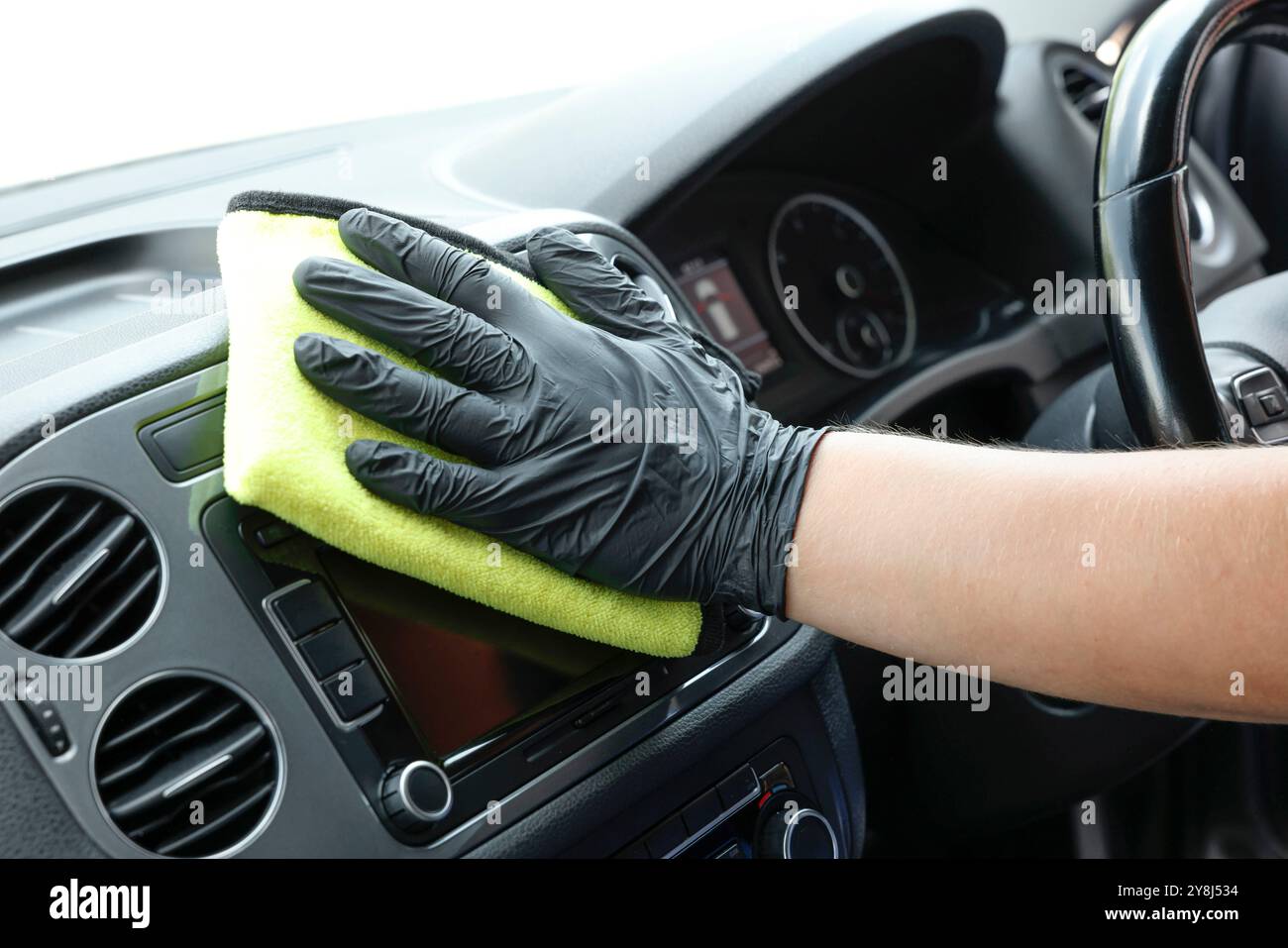 Man cleaning center console with rag, closeup Stock Photo - Alamy