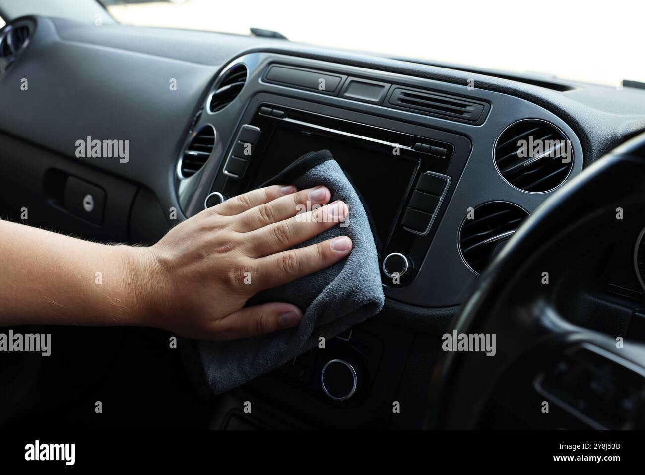Man cleaning center console with rag, closeup Stock Photo - Alamy