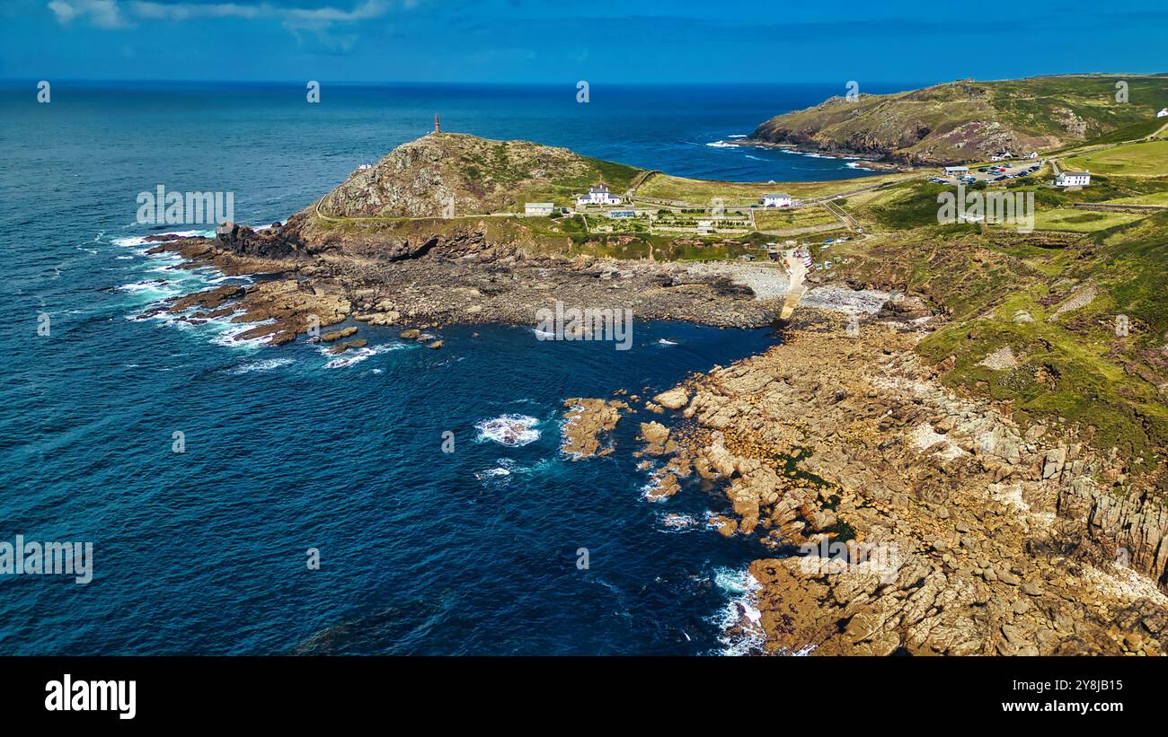 Aerial view of a coastal landscape featuring rocky shores, clear blue ...