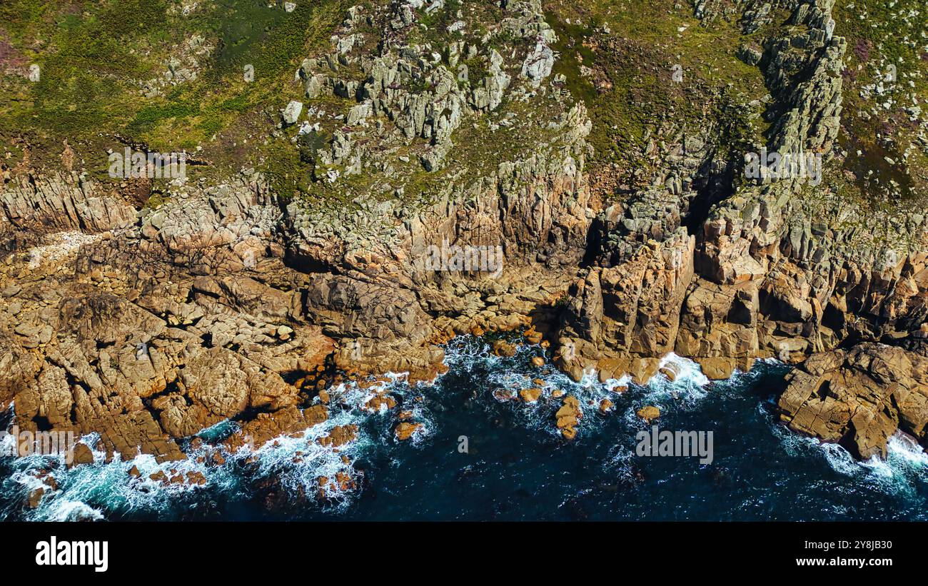 Aerial view of rugged coastline featuring rocky cliffs and crashing ...