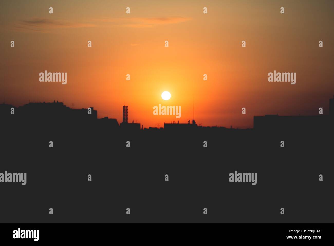 The rising sun casts a brilliant glow over the city's skyline ...