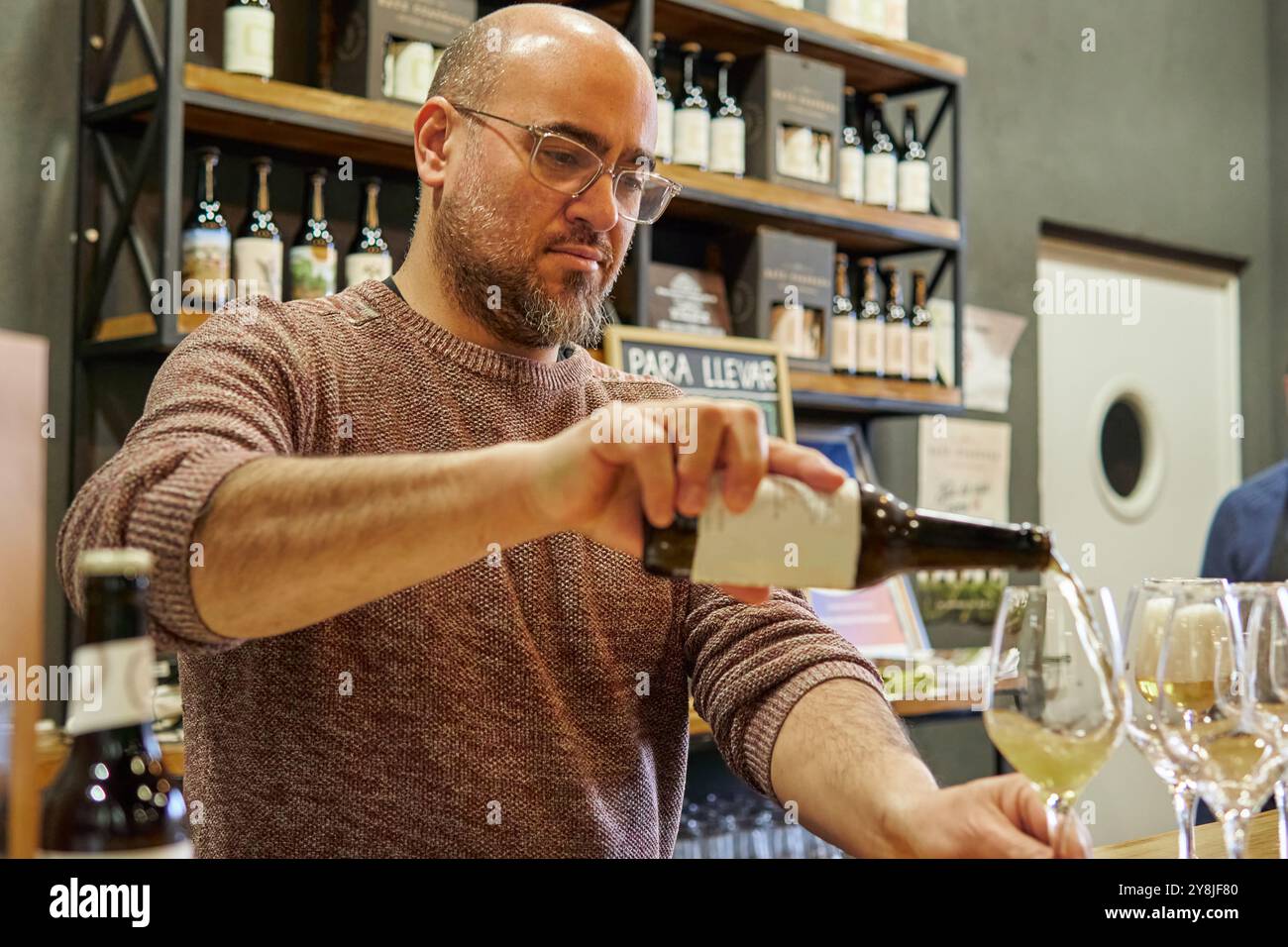 Pub owner pouring beer on glasses at his small business Stock Photo