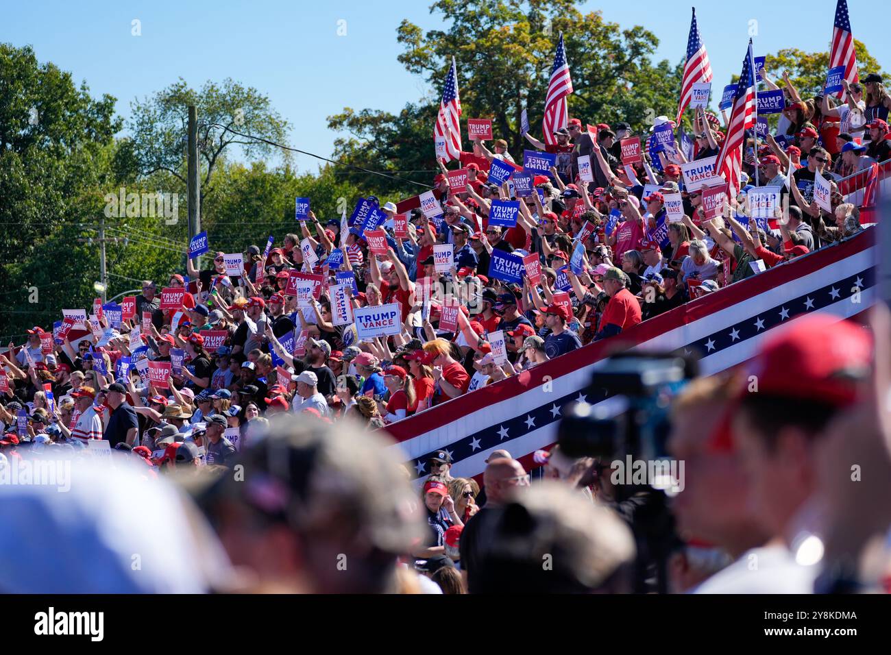 Butler, United States. 05th Oct, 2024. Rally goers wave signs at an ...