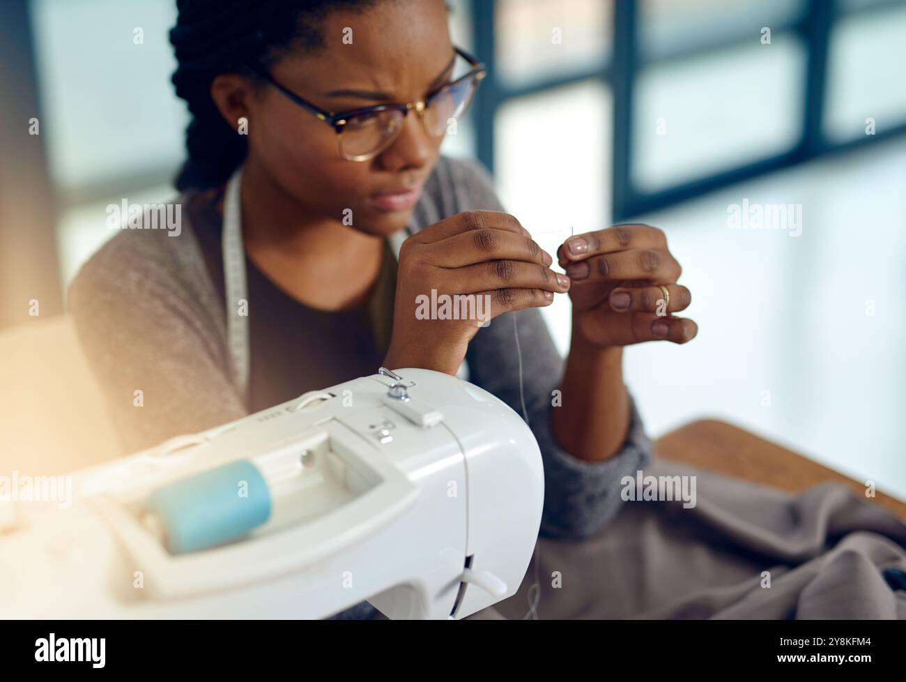 Sewing, machine and black woman with needle, designer and manufacturing ...