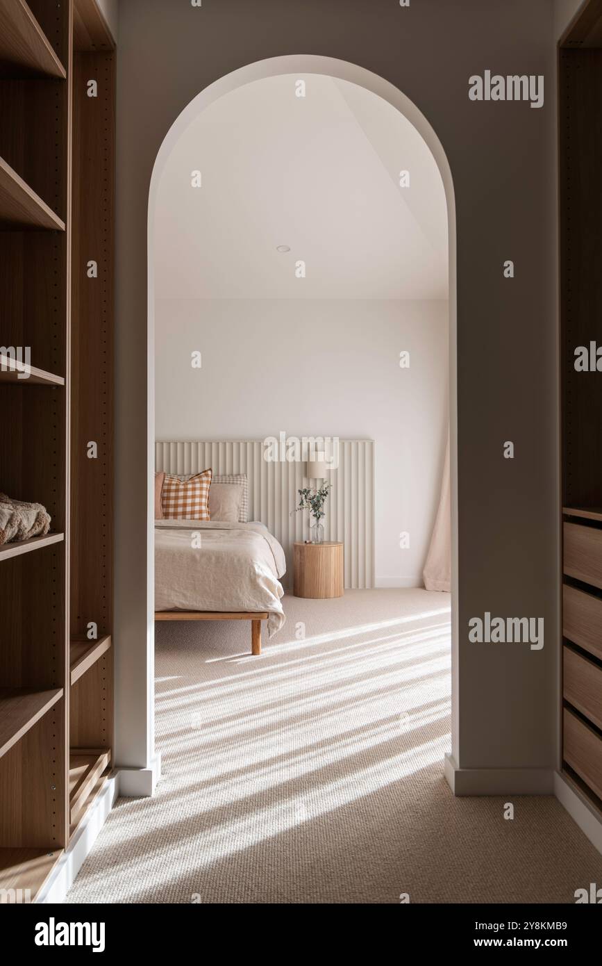 Beautiful walk-in robe interior design with elegant bedroom bathed in natural light. Stock Photo