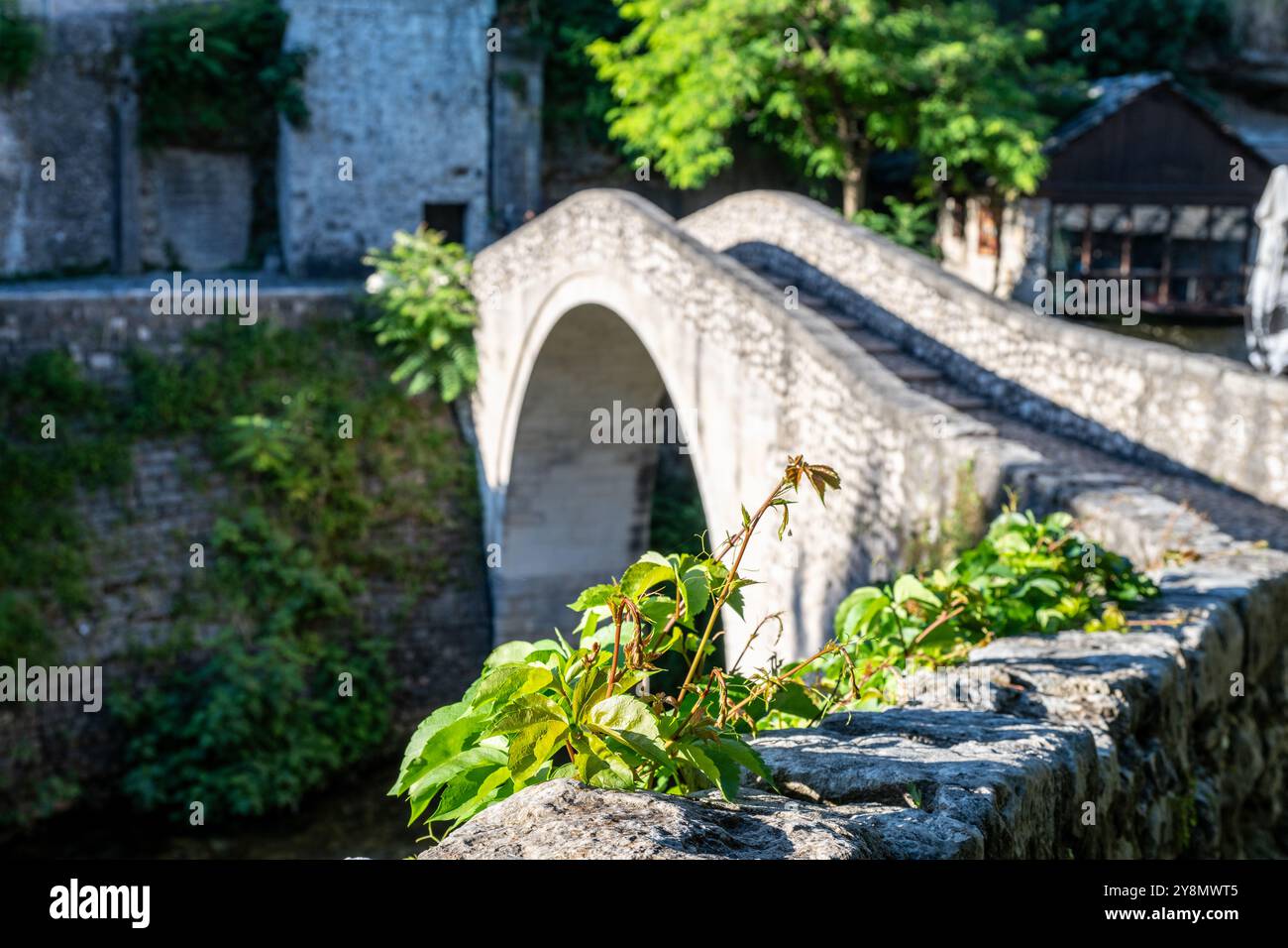 A bridge made of stone material in bright morning light. Stock Photo