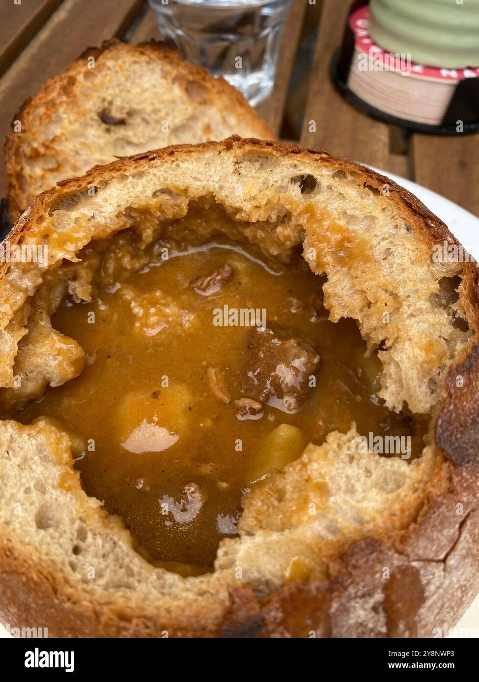 Beef goulash soup in bread bowl served in a Prague city centre restaurant, Czech Republic,2024 - Smartphone Captured Stock Image