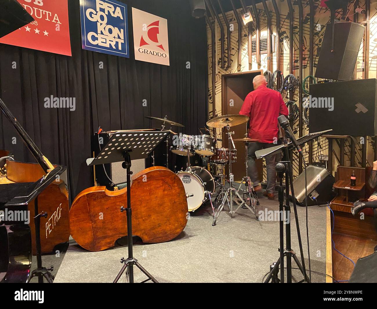 Reduta Jazz Club interior in Prague city centre, with jazz musician setting up on stage - Smartphone Captured Stock Image