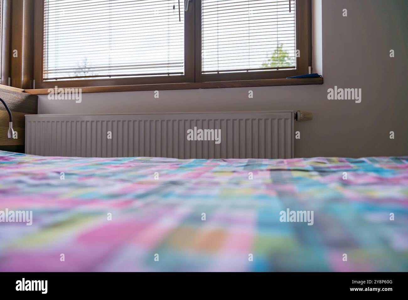 Cozy bedroom with radiator during the heating season Stock Photo - Alamy