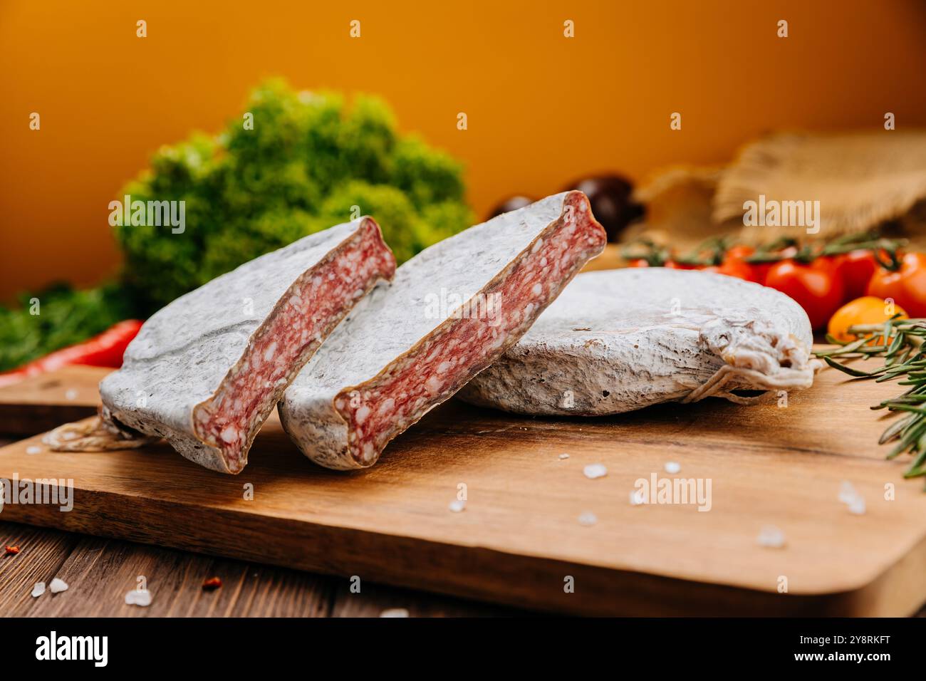 Dry-cured salami on board, ideal for rustic charcuterie presentations ...