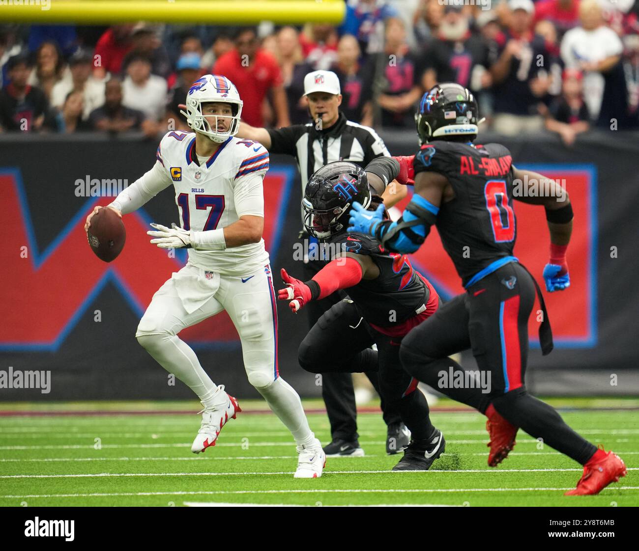 Houston, Tx, USA. 6th Oct, 2024. Bills quarterback Josh Allen (17) rolls out looking to pass, pursued by Texans defensive tackle Mario Edwards Jr. (97) during an NFL game on October 6, 2024 in Houston. The Texans won, 23-20, on a walk-off field goal by Ka'imi Fairbairn. (Credit Image: © Scott Coleman/ZUMA Press Wire) EDITORIAL USAGE ONLY! Not for Commercial USAGE! Stock Photo