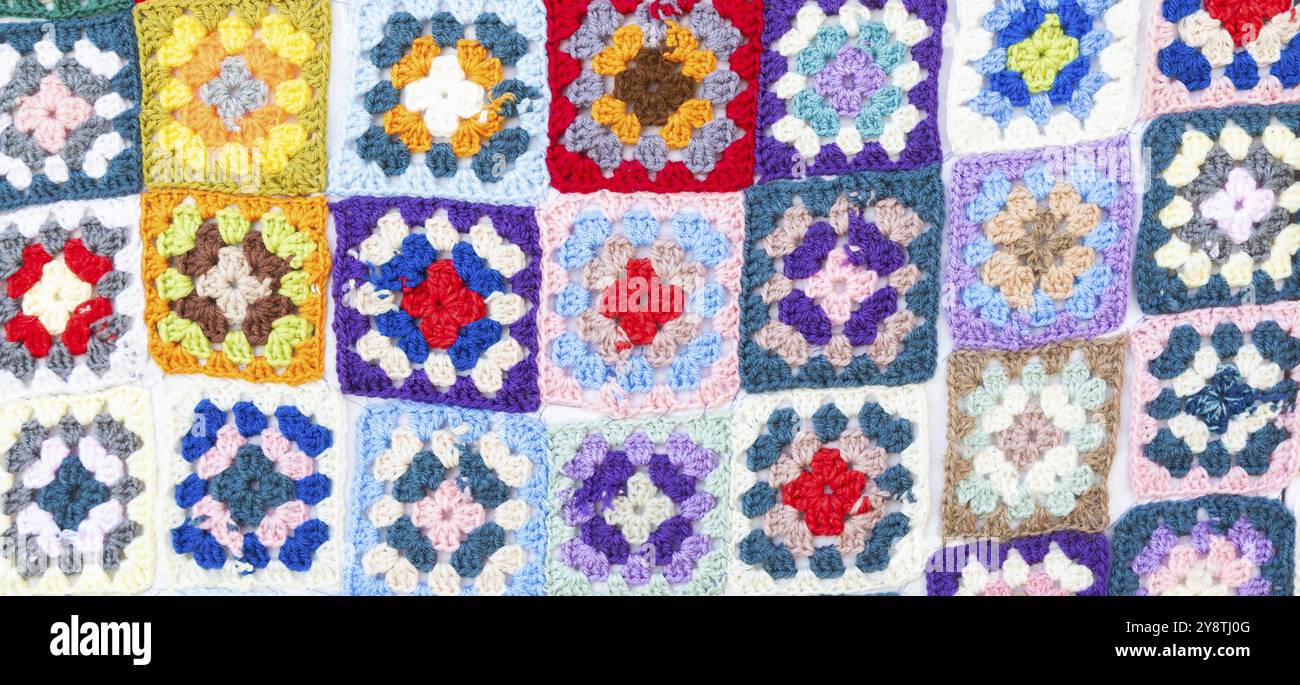 Multi colored blanket in wool, geometric background, retro decorative pattern Stock Photo
