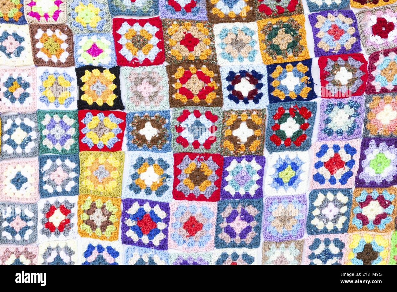 Multi colored blanket in wool, geometric background, retro decorative pattern Stock Photo