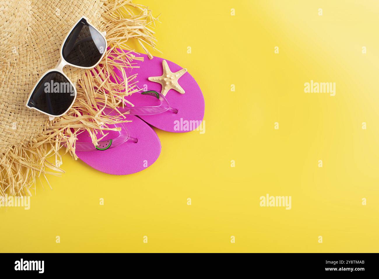 Flip flops straw hat sunglesses and starfish on yellow background ...