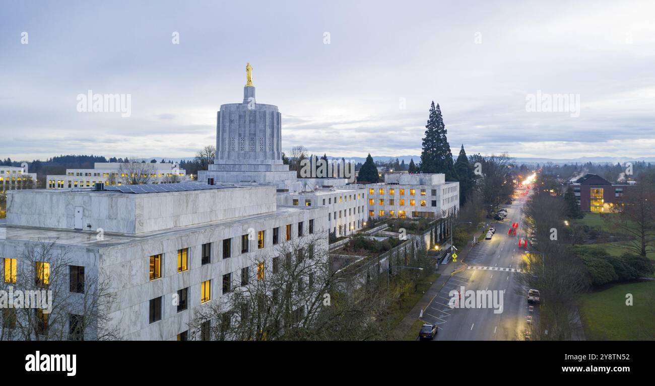 The state capital building adorned with the Oregon Pioneer with downtown Salem in the background Stock Photo