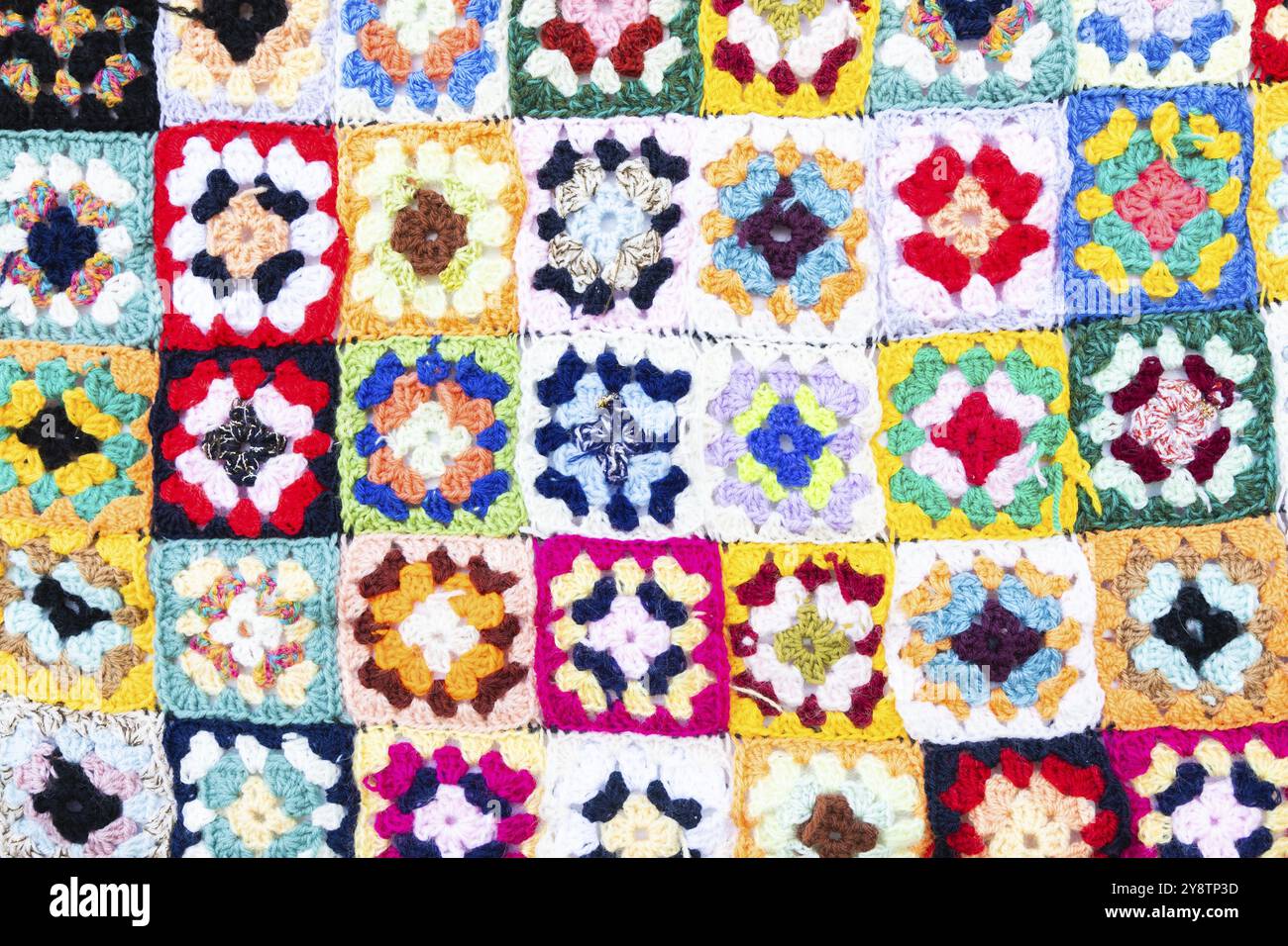 Multi colored blanket in wool, geometric background, retro decorative pattern Stock Photo
