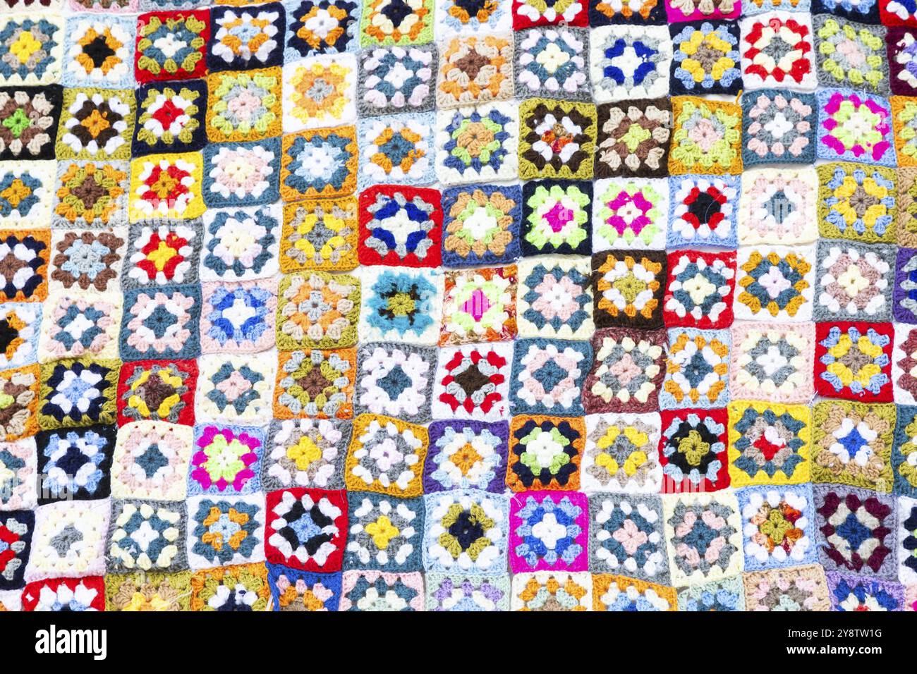 Multi colored blanket in wool, geometric background, retro decorative pattern Stock Photo