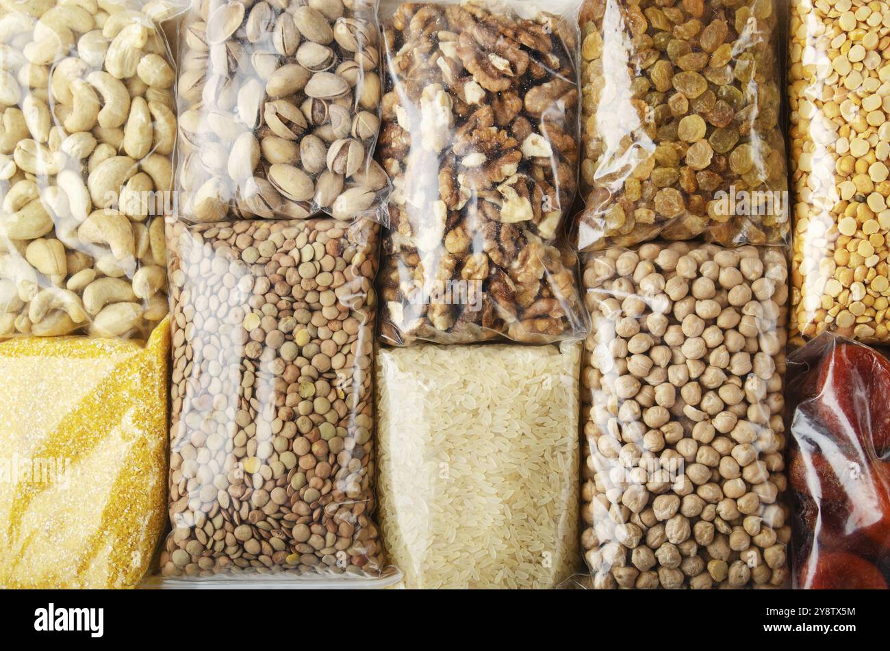 Flat lay view at background of plastic containres with non-perishable foods on kitchen table Stock Photo