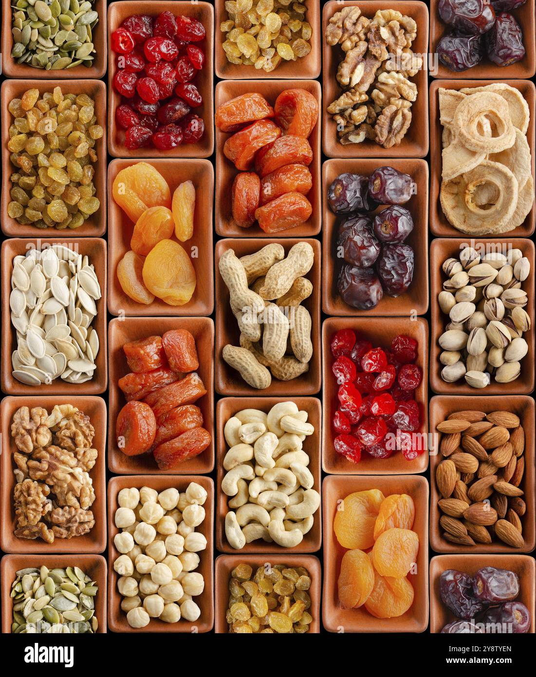 Seamless flat lay food background of dehydrated fruits, seeds and nuts on black. Non-perishable antioxidant gluten free foods concept Stock Photo