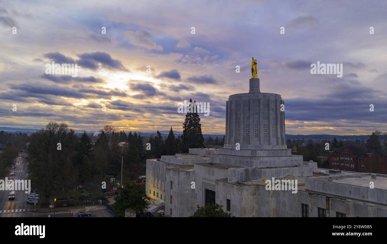 The state capital building adorned with the Oregon Pioneer with downtown Salem in the background Stock Photo