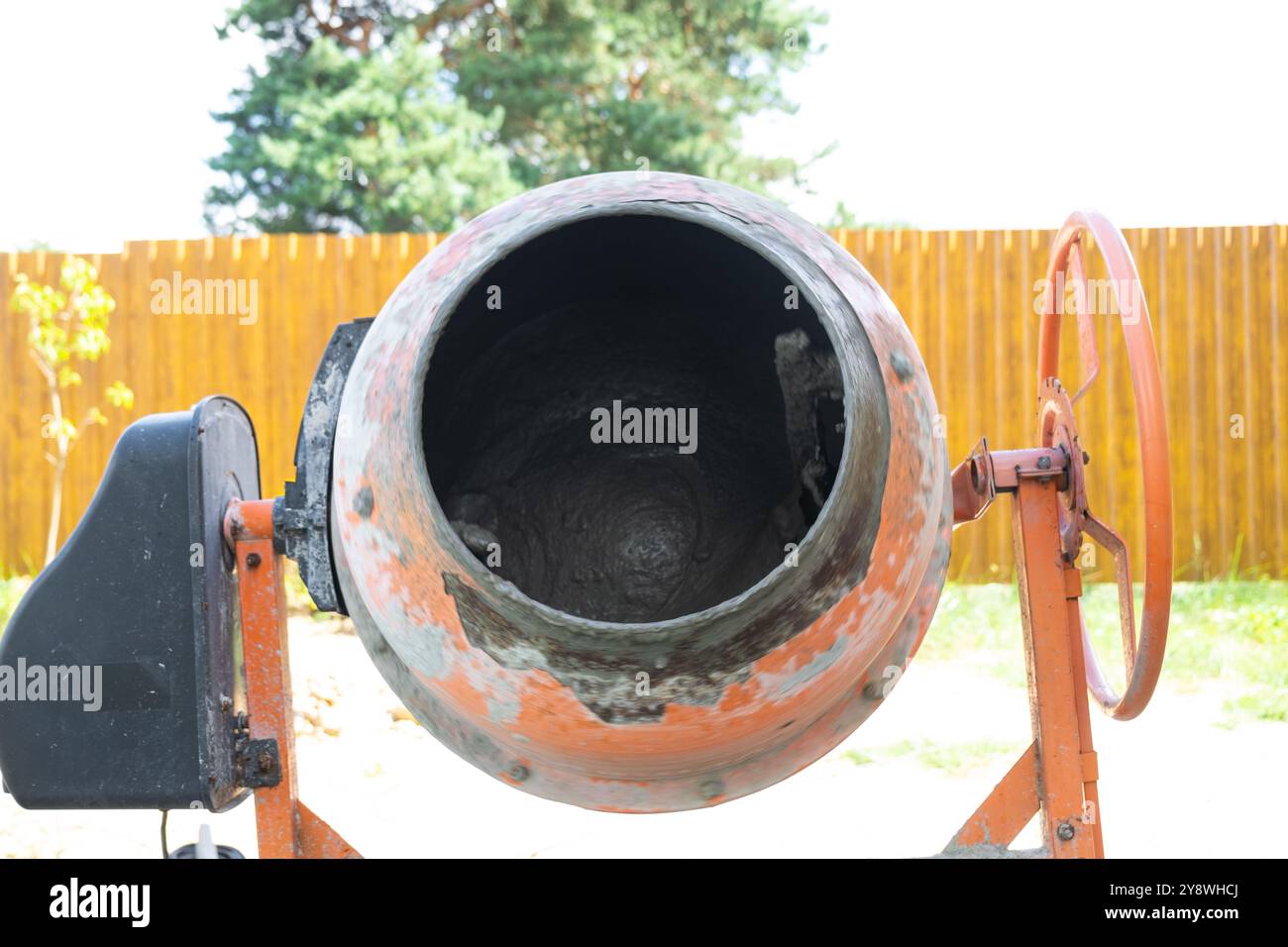 Mixing mortar in a handheld portable concrete mixer Stock Photo