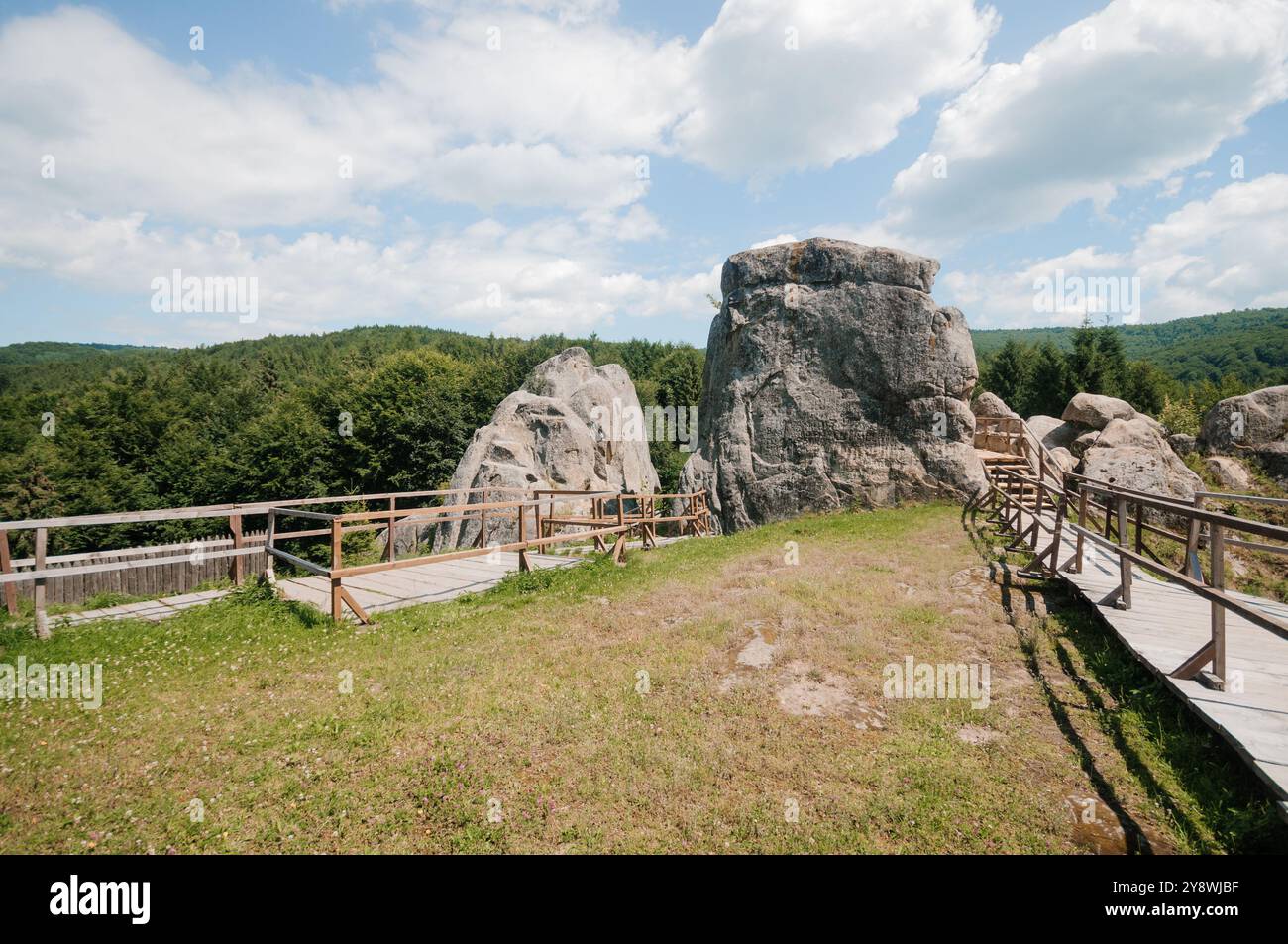 Serene Rocky Landscape Under a Blue Sky with Lush Greenery Stock Photo ...