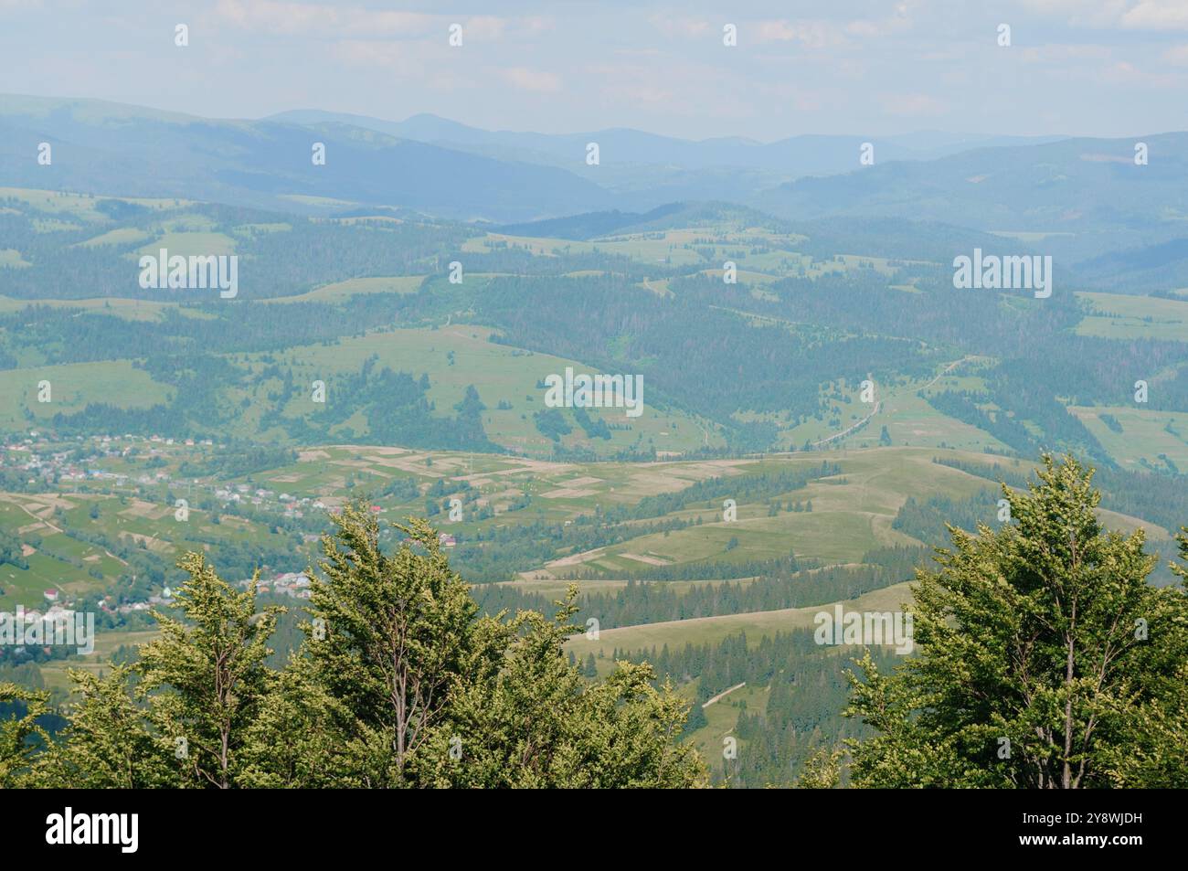 A Serene Landscape of Rolling Hills and Lush Greenery under a Clear ...